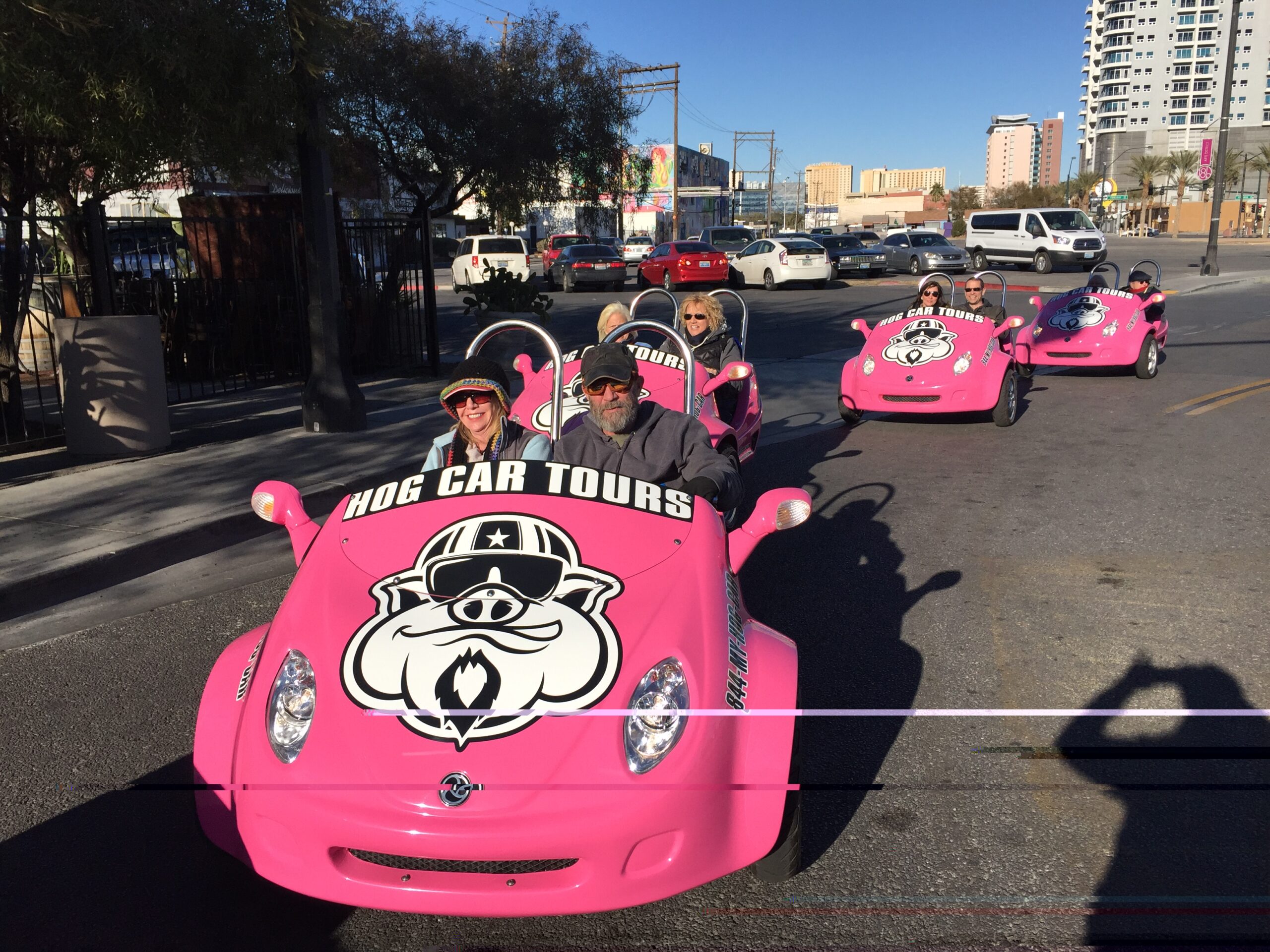 Line of pink Hog Cars